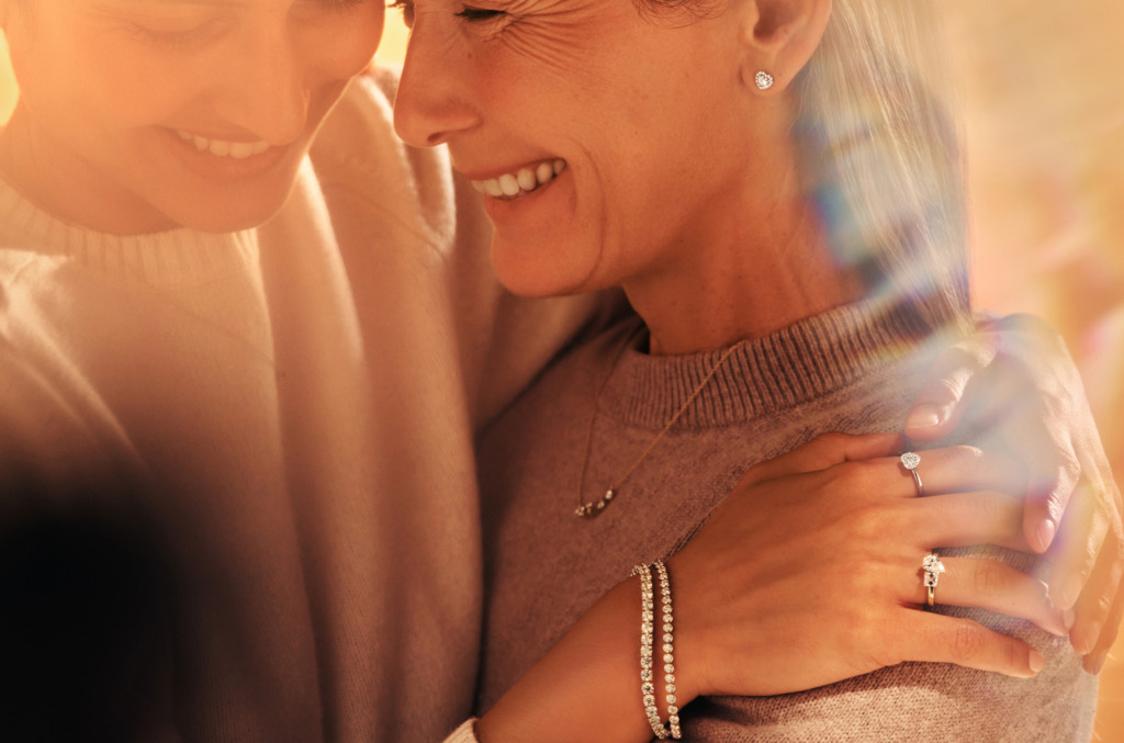 mom and daughter holding each other wearing natural diamonds shown as heirlooms